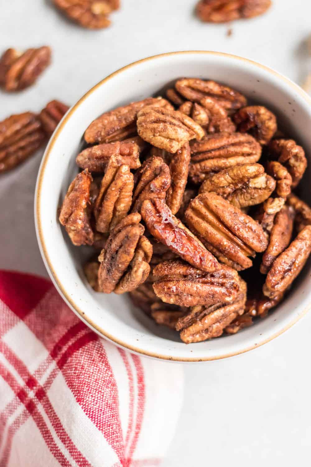 Maple Vanilla Spiced Pecans in white bowl with gold trim