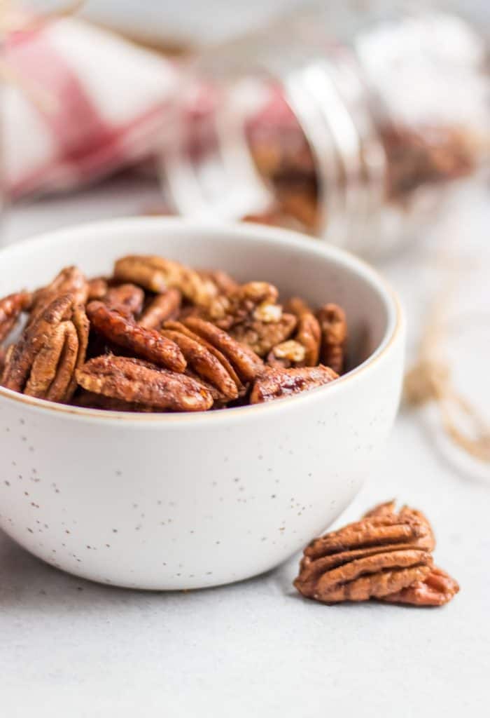 Simple roasted and maple sweetened pecans with a dusting of cinnamon and hints of vanilla are the perfect snack, holiday treat, salad topper and more! This easy spiced pecan recipe makes perfect holiday gifts as well!