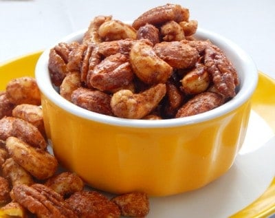 Yellow bowl with maple candied pecans, cashews and almonds.