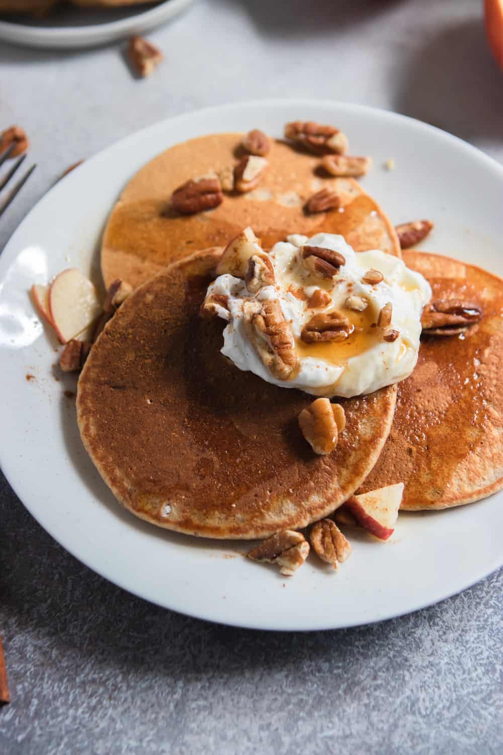 Apple Oatmeal Pancakes with maple, pecans and yogurt.