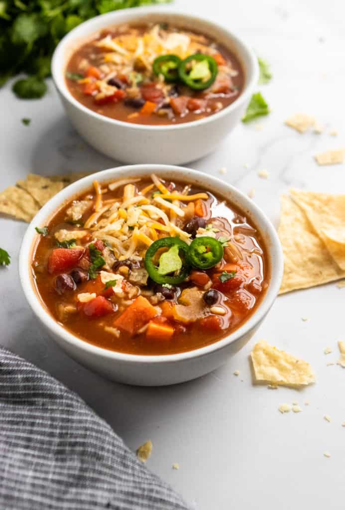 Black Bean and Rice Soup with shredded cheese and jalapeno.