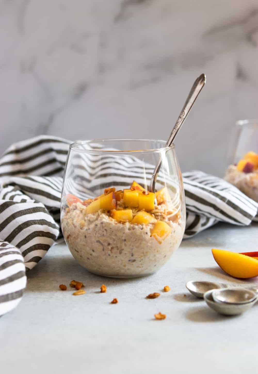 Oatmeal in glass with granola and fresh fruit.