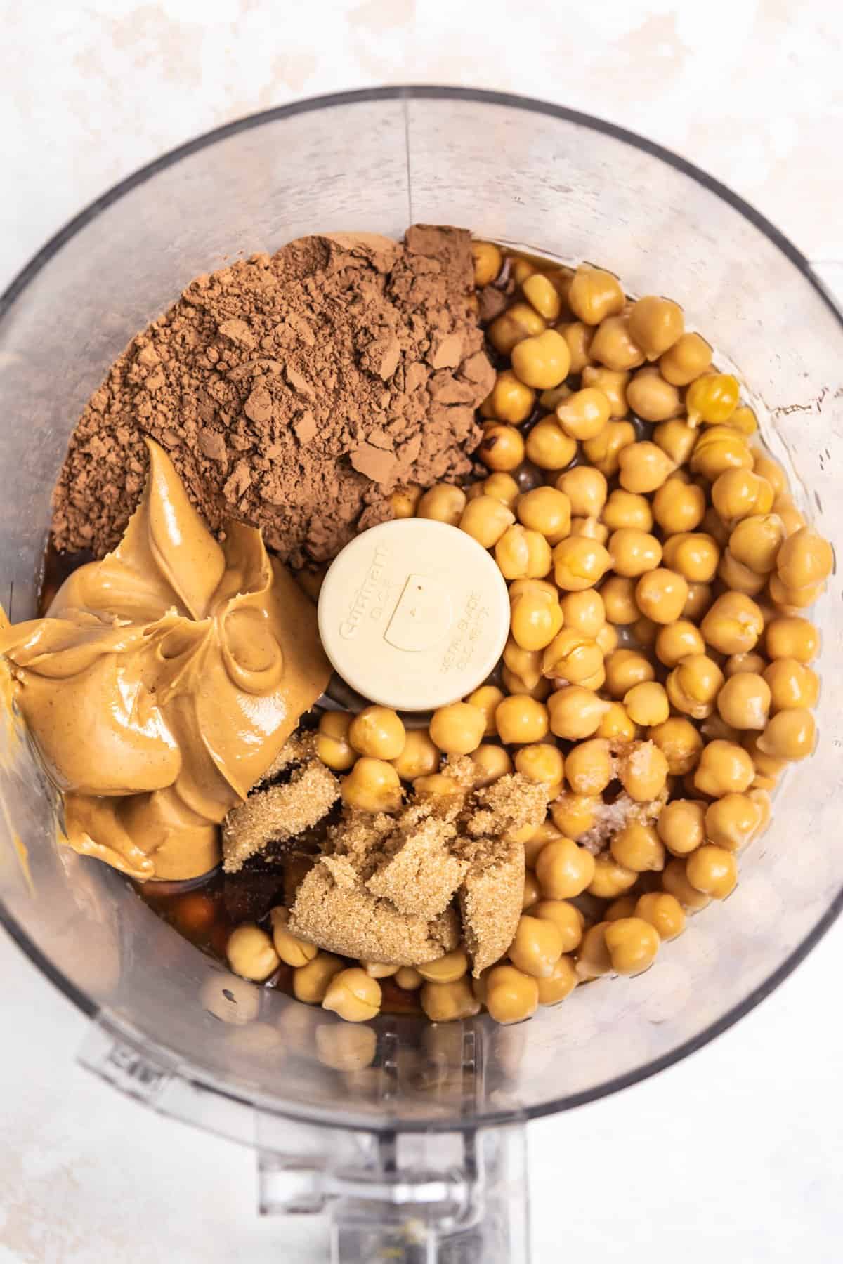 Garbanzo beans, cocoa powder, peanut butter, maple and other ingredients in food processor.