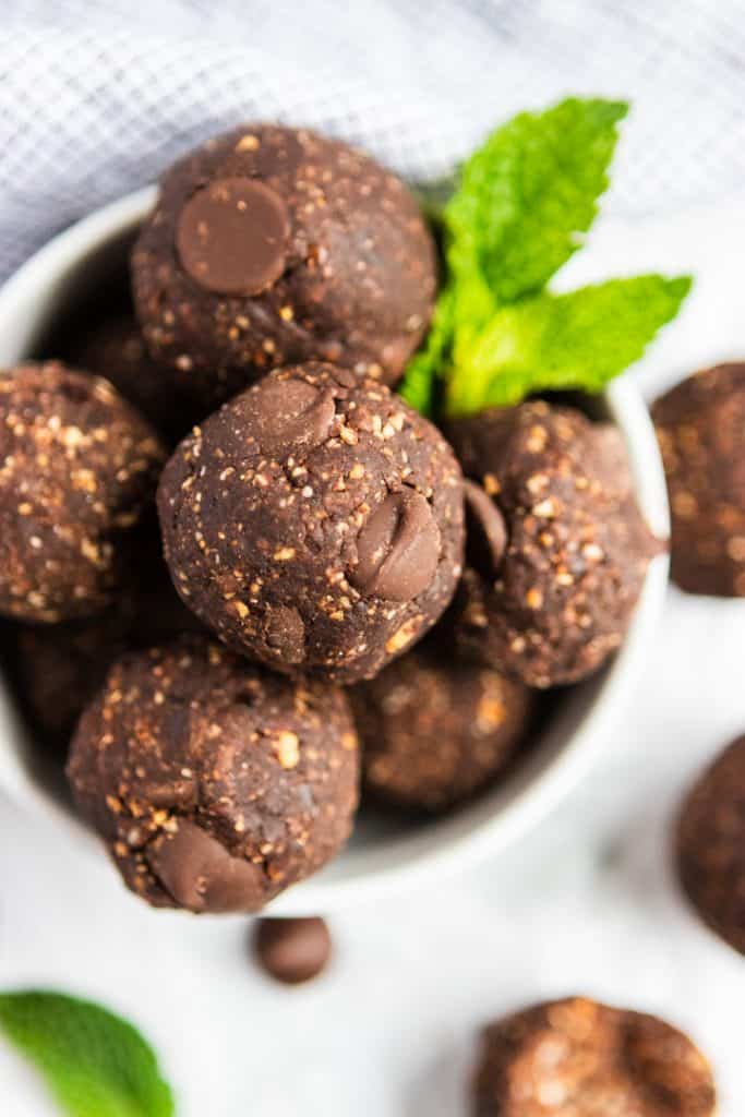 Mint Chocolate No Bake Brownie Bites in bowl with mint leaf.