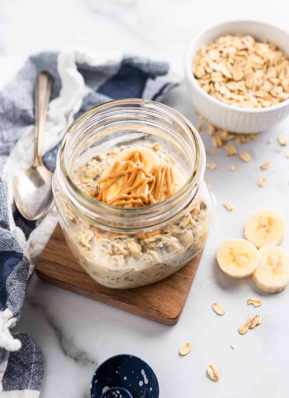 Overnight oats in jar with peanut butter and banana on top.
