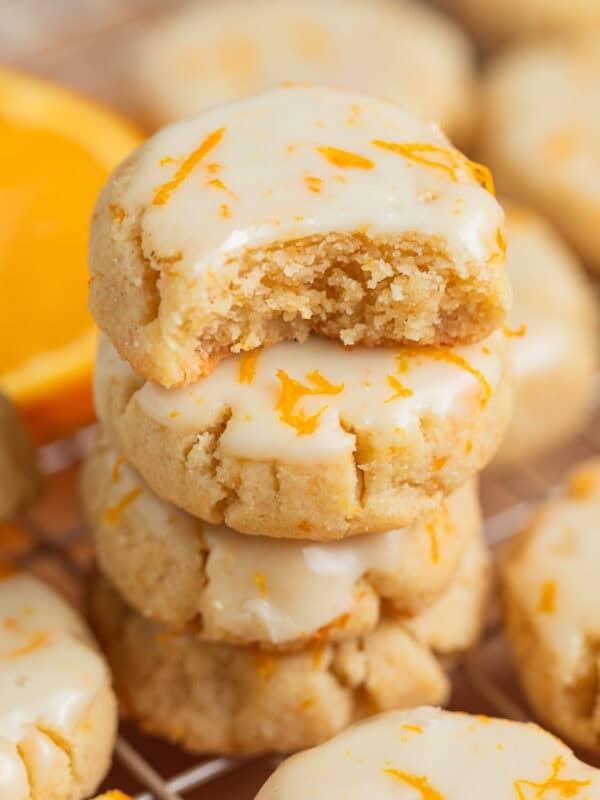 Stack of gluten free almond flour cookies with bite taken out of top cookie.