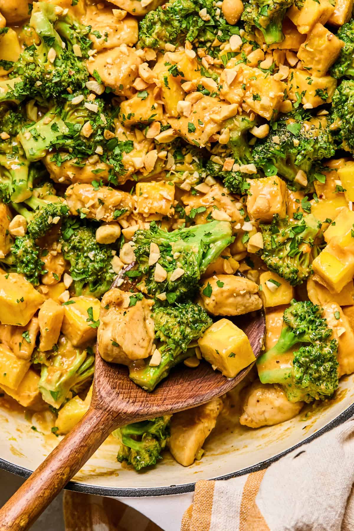 Mango peanut chicken stir fry in pan.