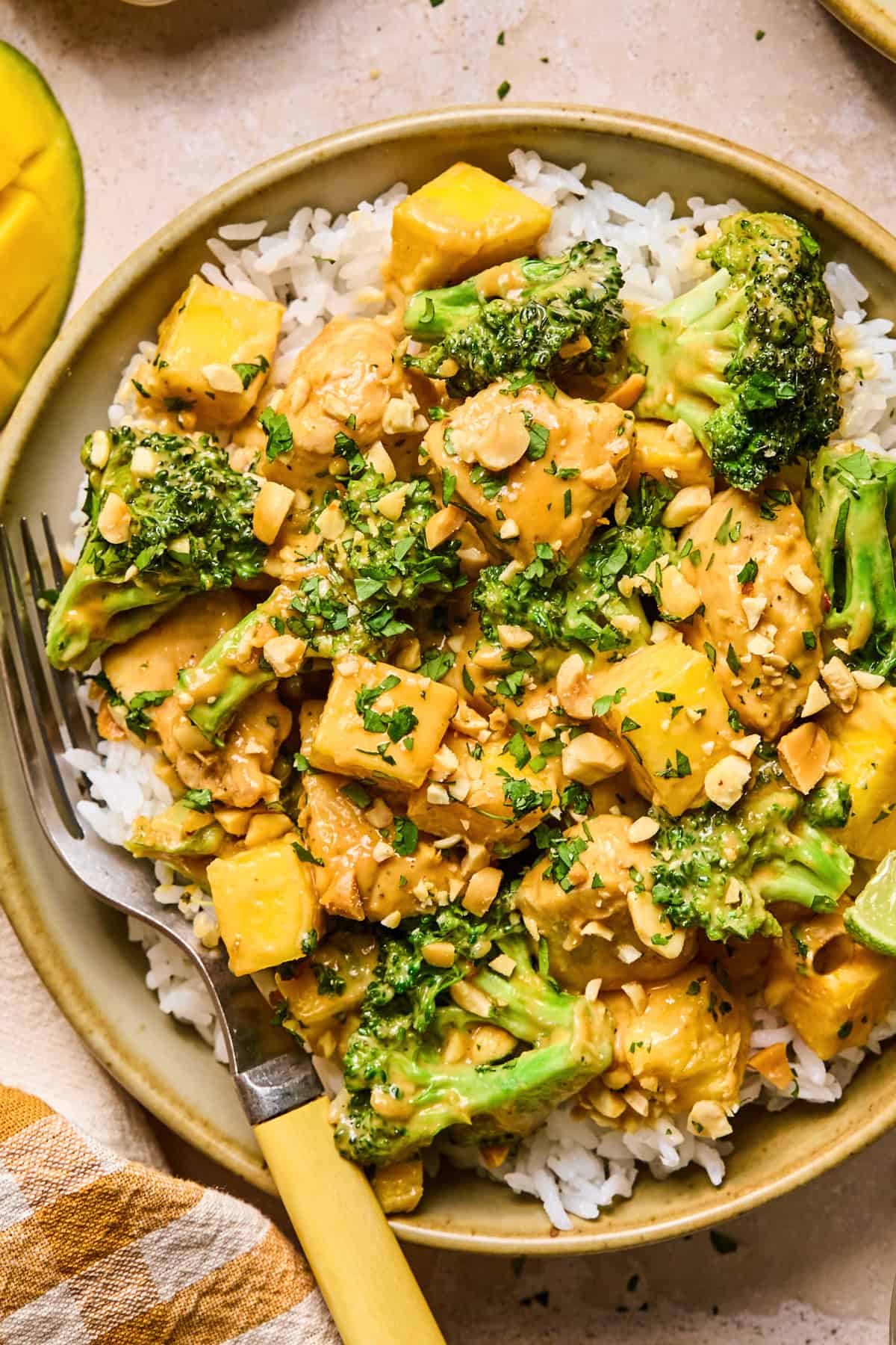 Mango peanut chicken stir fry over rice with broccoli.