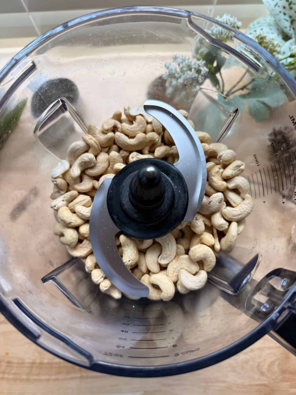 Raw cashews in food processor.