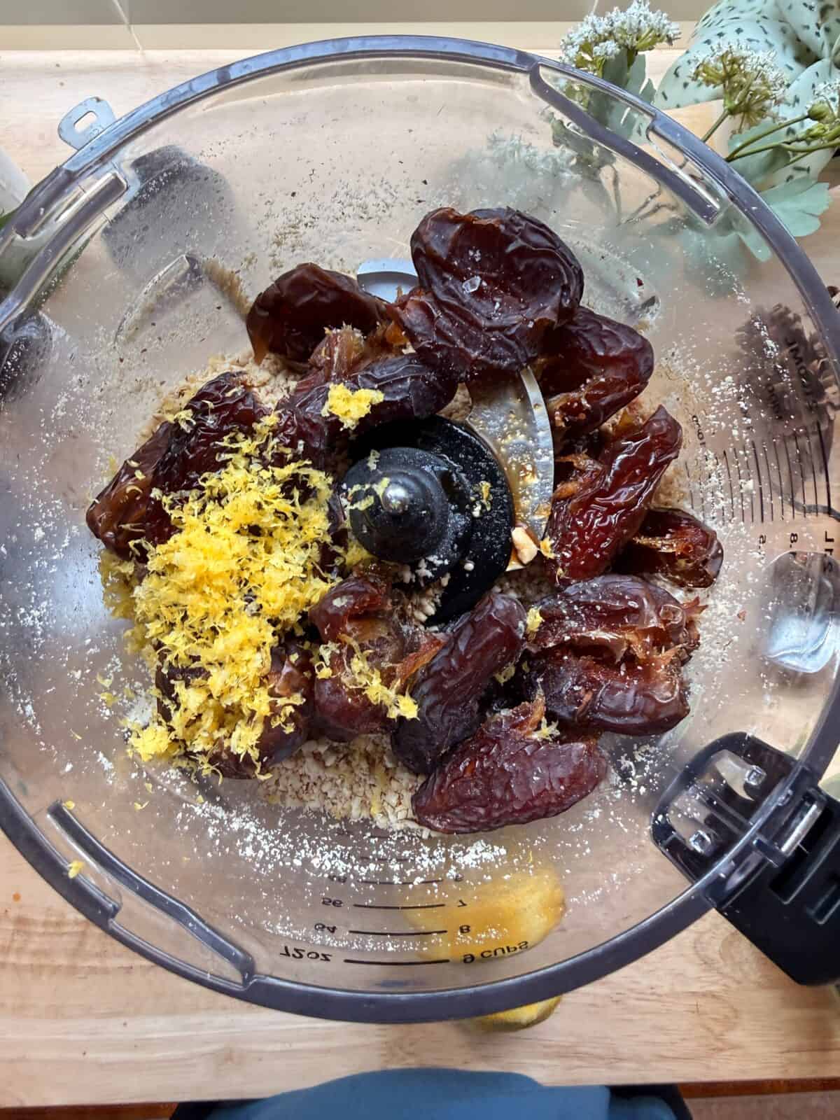 Dates and lemon zest in food processor.