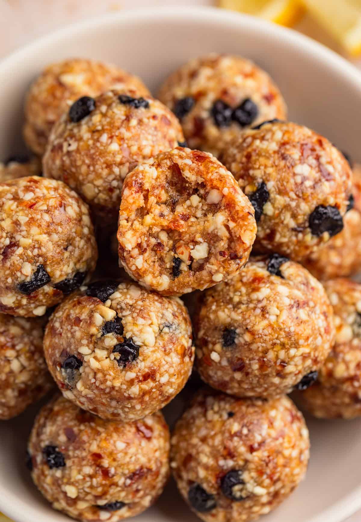 Bowl with energy balls and bite taken out of top ball.