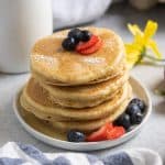 Stack of dairy free pancakes with berries.