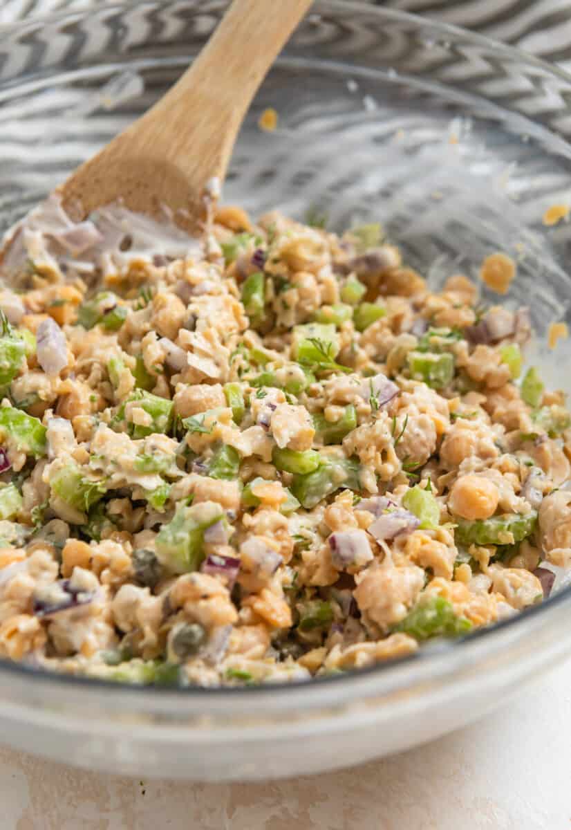 Chickpea dill tuna mixed in bowl with wooden spoon.