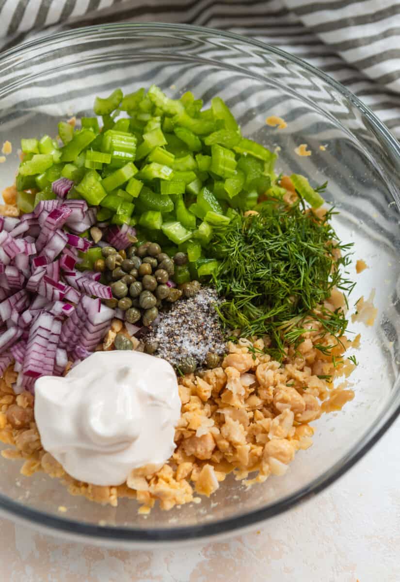Chickpea tuna salad recipe ingredients in mixing bowl before stirring.