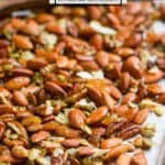 Roasted trail mix with almonds, pecans, coconut and other ingredients on sheet pan.