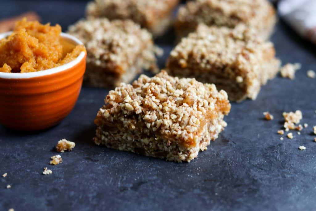 No Bake Pumpkin Crumble Bars. These simple no bake bars will be your new favorite treat! A handful of wholesome ingredients including almonds, pecans, medjool dates and cinnamon along with everyone's fall favorite: pumpkin! They will be ready in minutes! lemonsandzest.com