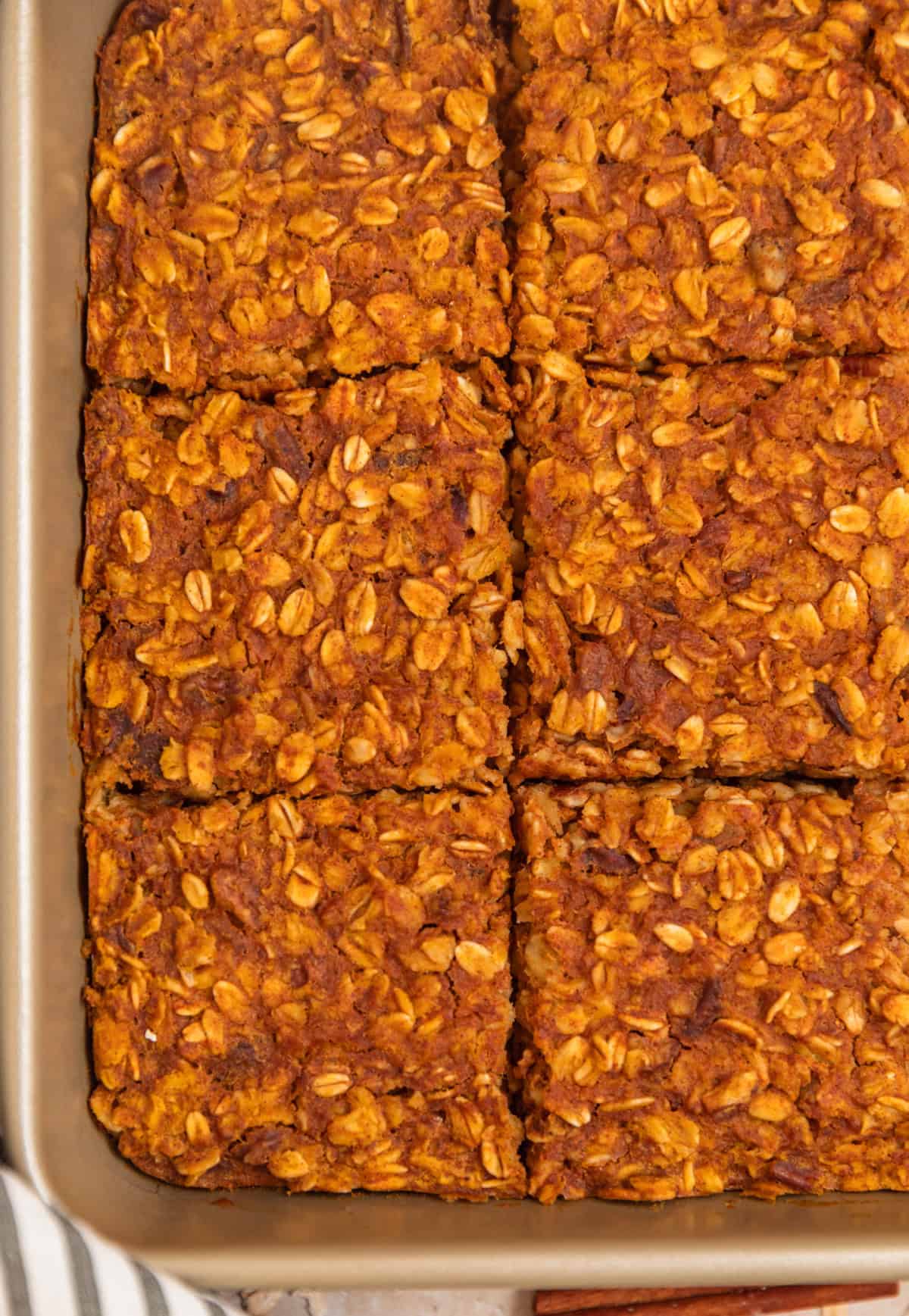Sliced pumpkin oatmeal bake recipe in pan.