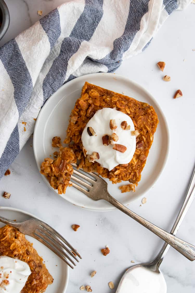 Overhead view of pumpkin baked oats on white plate.