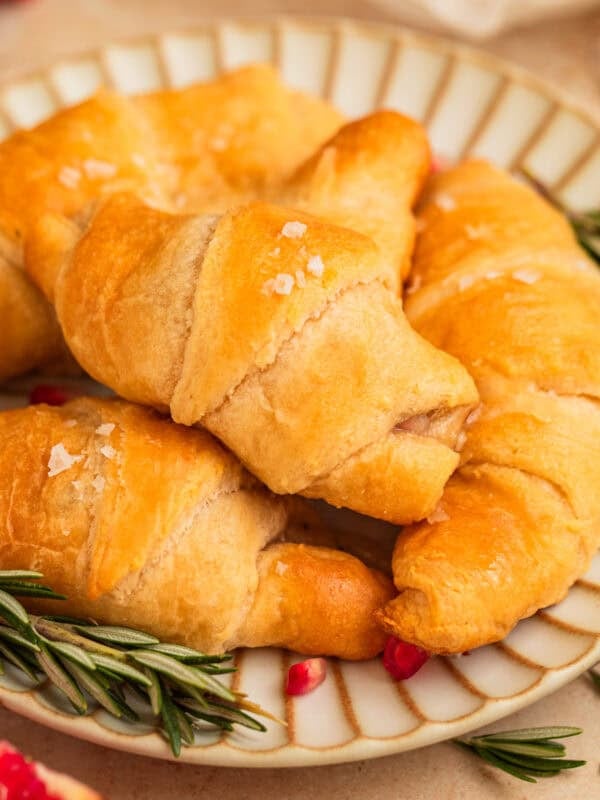Crescent rolls with sea salt on top on plate.