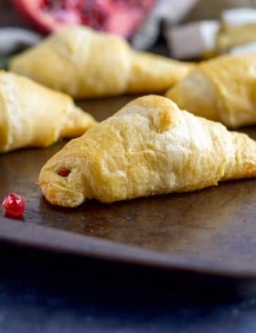 Skip the bread and butter! Add these Pomegranate, Rosemary and Brie Stuffed Crescent Rolls to your dinner and everyone will beg for seconds!