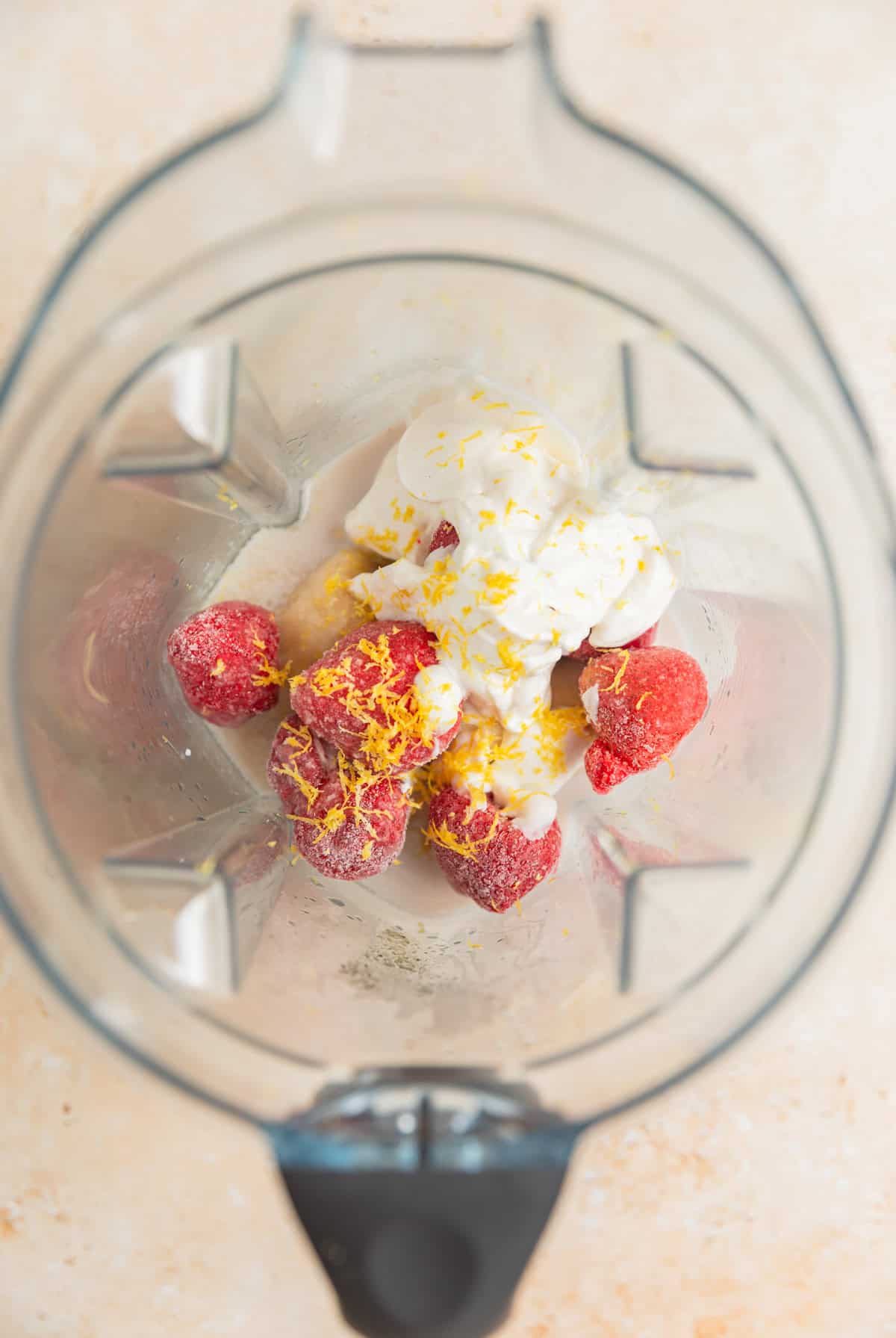 Frozen strawberries, yogurt, lemon zest, frozen banana and other ingredients in blender.