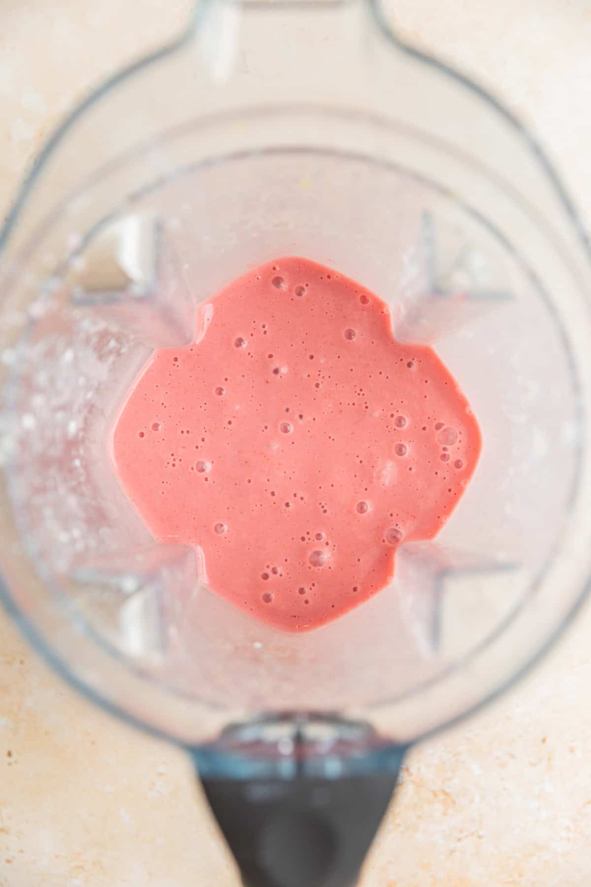 Strawberry lemon smoothie mixture blended in blender.