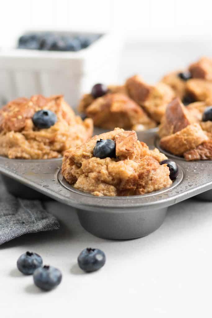 Blueberry Baked French Toast Muffins. French Toast in the form of muffins? Breakfast just upped its game big time. Juicy blueberries and a touch of maple. #frenchtoast #bakedfrenchtoast #breakfast #makeahead