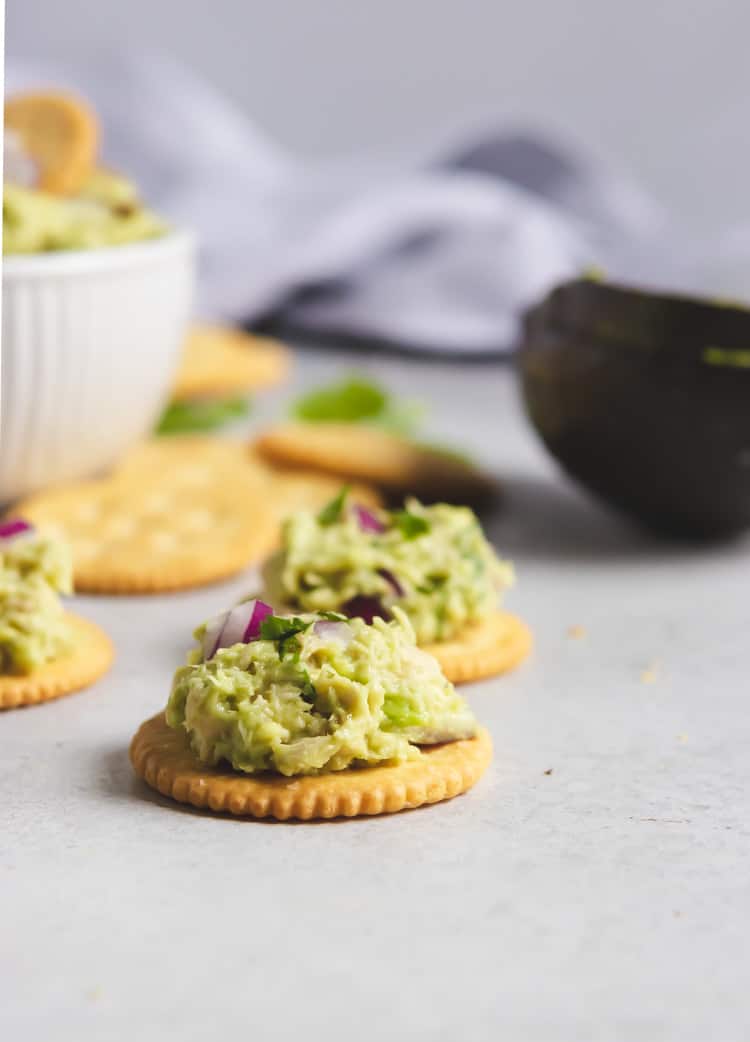 Avocado tuna salad on crackers.