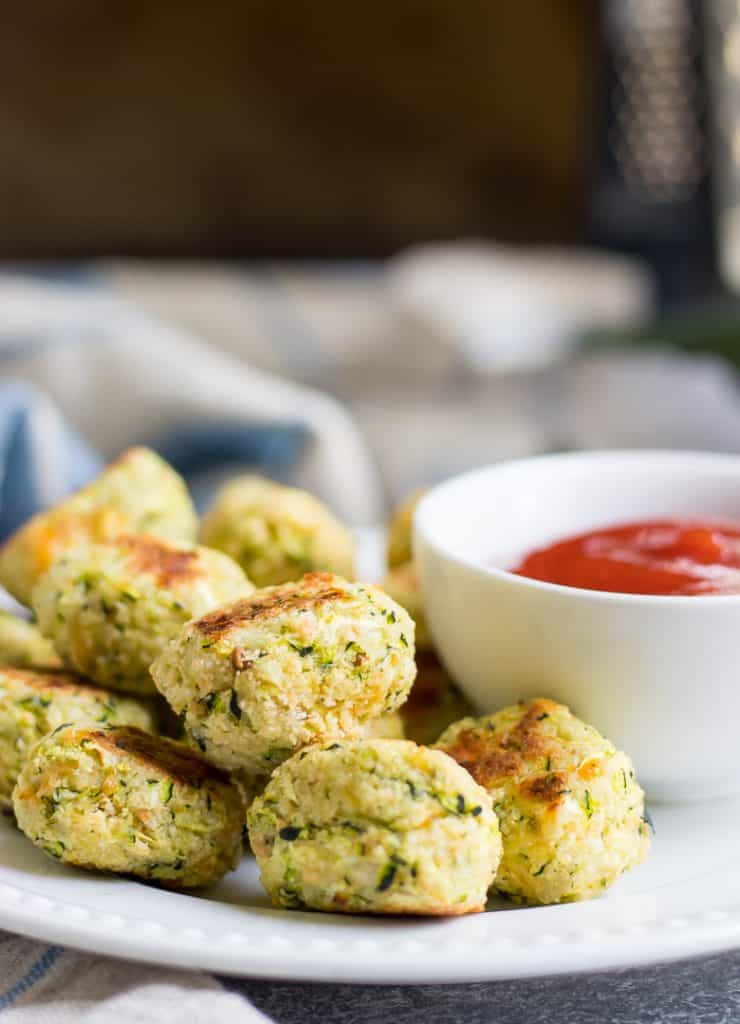 These Cheesy Zucchini Tots are a fun way to get the family to eat some veggies with a smile! They are simple to whip up and perfect for dipping into your favorite sauce!