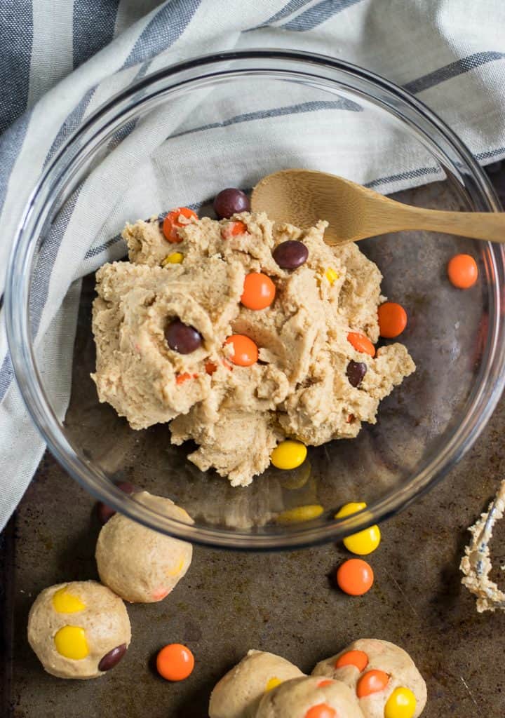 Have your cookie dough and eat it too! Egg-less, edible cookie dough that is! These Peanut Butter Reese's Pieces Cookie Dough Bites are a simple way to add a fun sweet treat this Halloween or any other time of the year when you are craving all things peanut butter! #cookiedough #peanutbuttercookiedough #reeses #reesespieces #nobake #halloween #simplerecipe