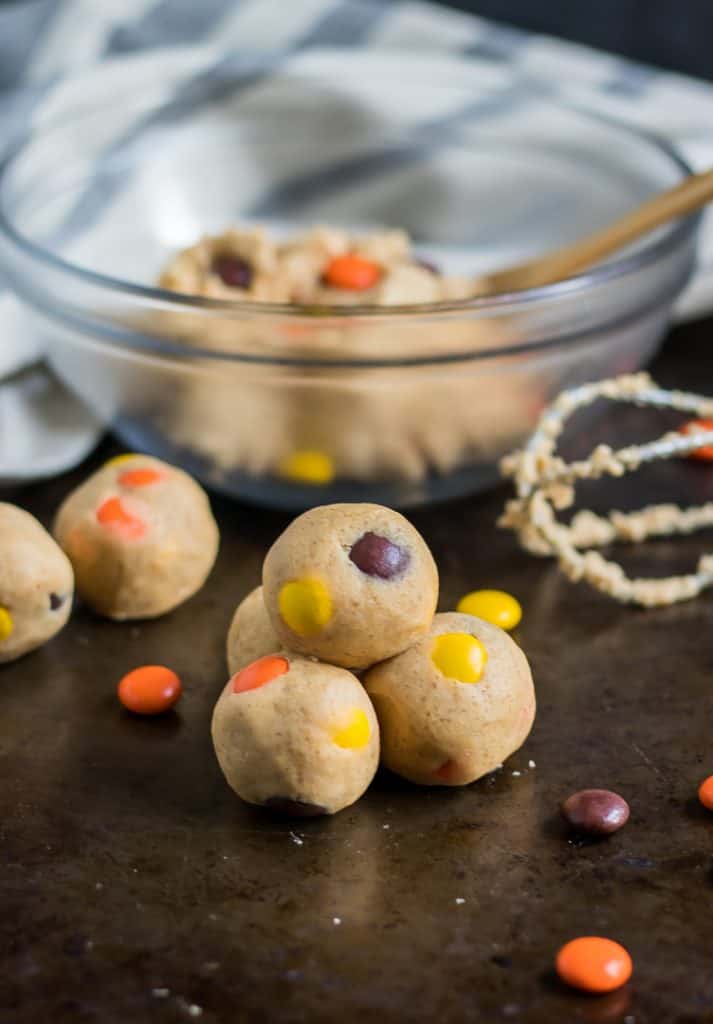 Have your cookie dough and eat it too! Egg-less, edible cookie dough that is! These Peanut Butter Reese's Pieces Cookie Dough Bites are a simple way to add a fun sweet treat this Halloween or any other time of the year when you are craving all things peanut butter! #cookiedough #peanutbuttercookiedough #reeses #reesespieces #nobake #halloween #simplerecipe