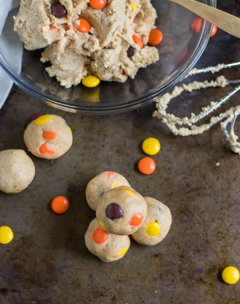 Have your cookie dough and eat it too! Egg-less, edible cookie dough that is! These Peanut Butter Reese's Pieces Cookie Dough Bites are a simple way to add a fun sweet treat this Halloween or any other time of the year when you are craving all things peanut butter! #cookiedough #peanutbuttercookiedough #reeses #reesespieces #nobake #halloween #simplerecipe