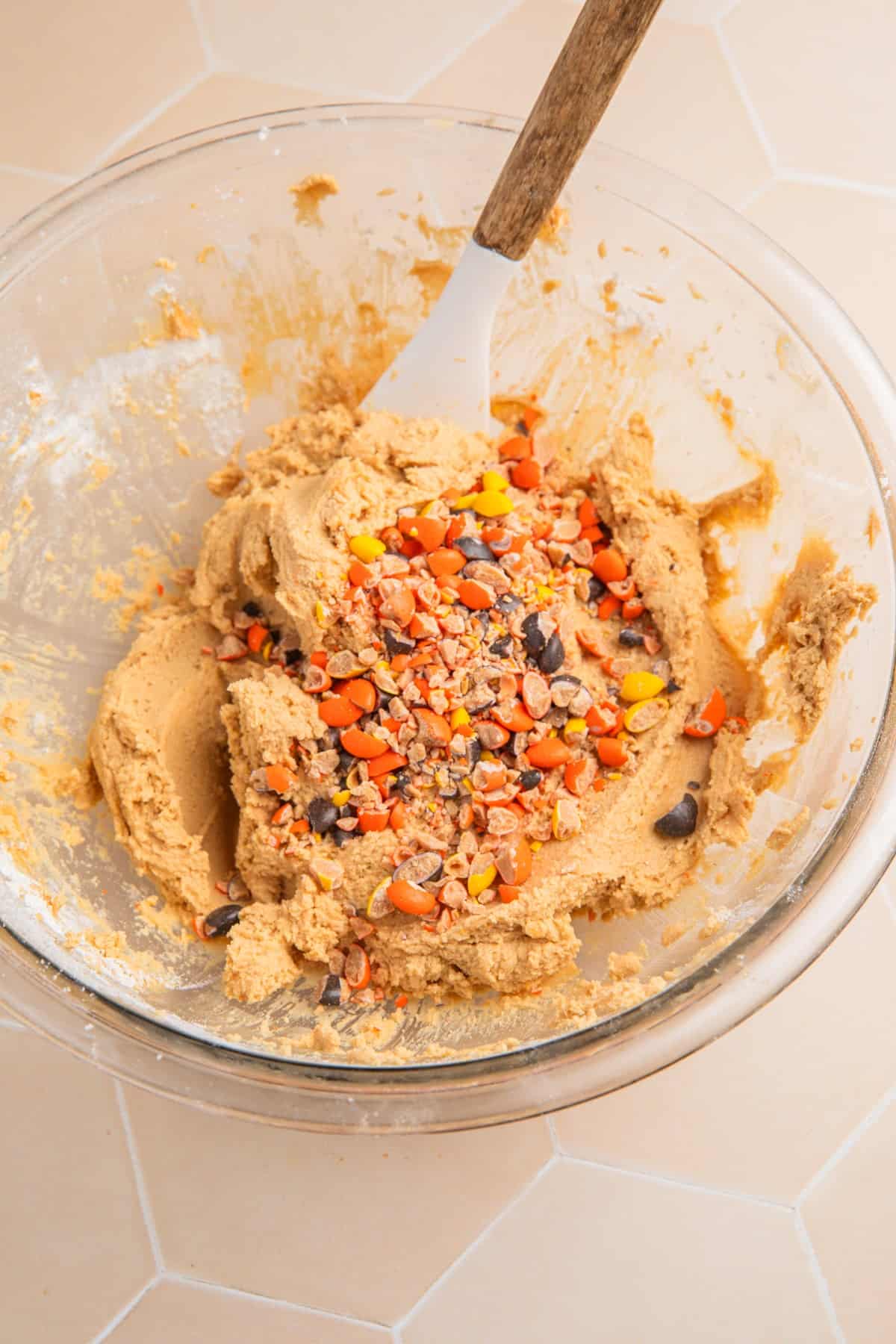 Crushed peanut butter candies added to cooke dough in bowl
