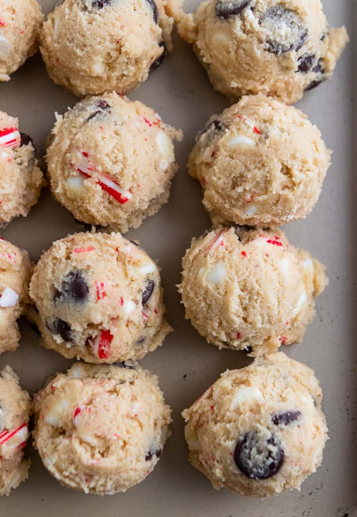 Peppermint Chocolate Chip Cookie dough scooped on cookie sheet.