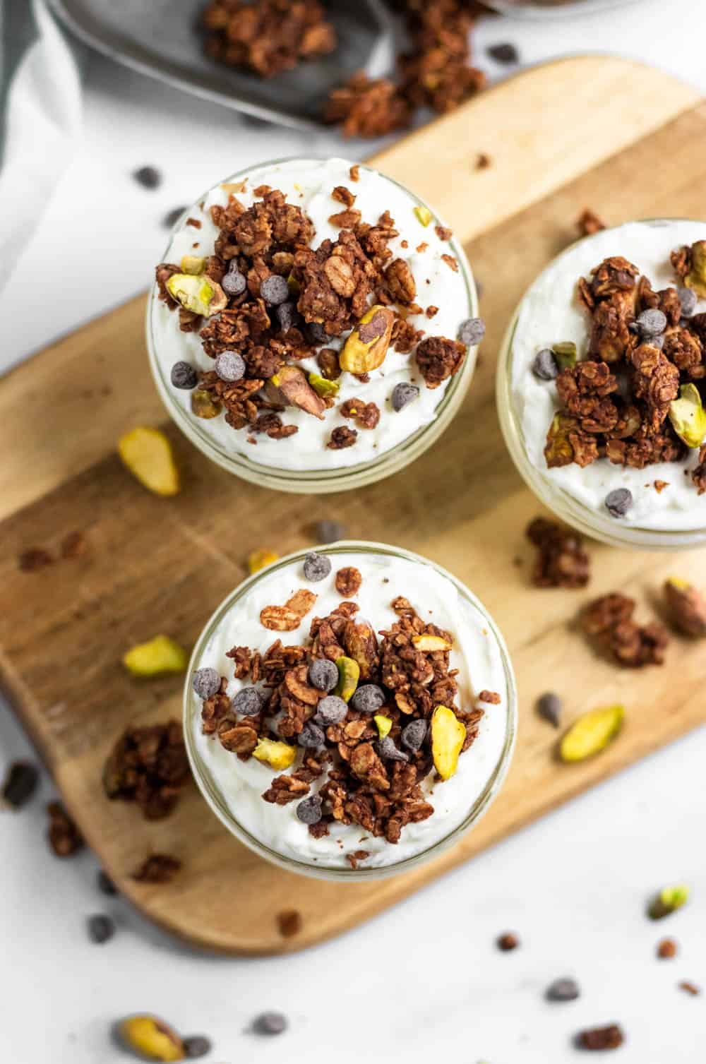 Overhead view of chocolate granola on yogurt.