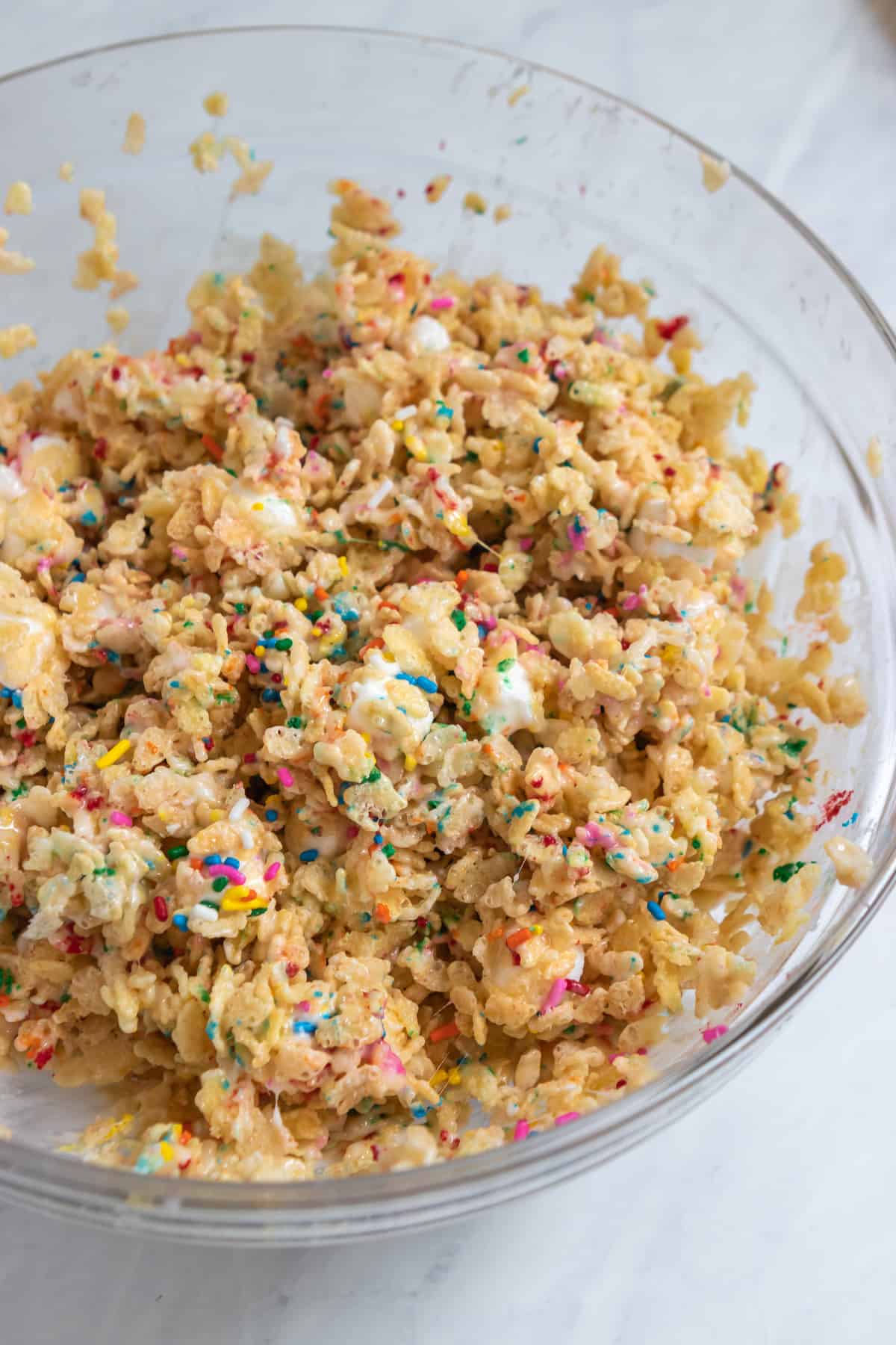 Mixing bowl with funfetti rice krispie treat mixture.