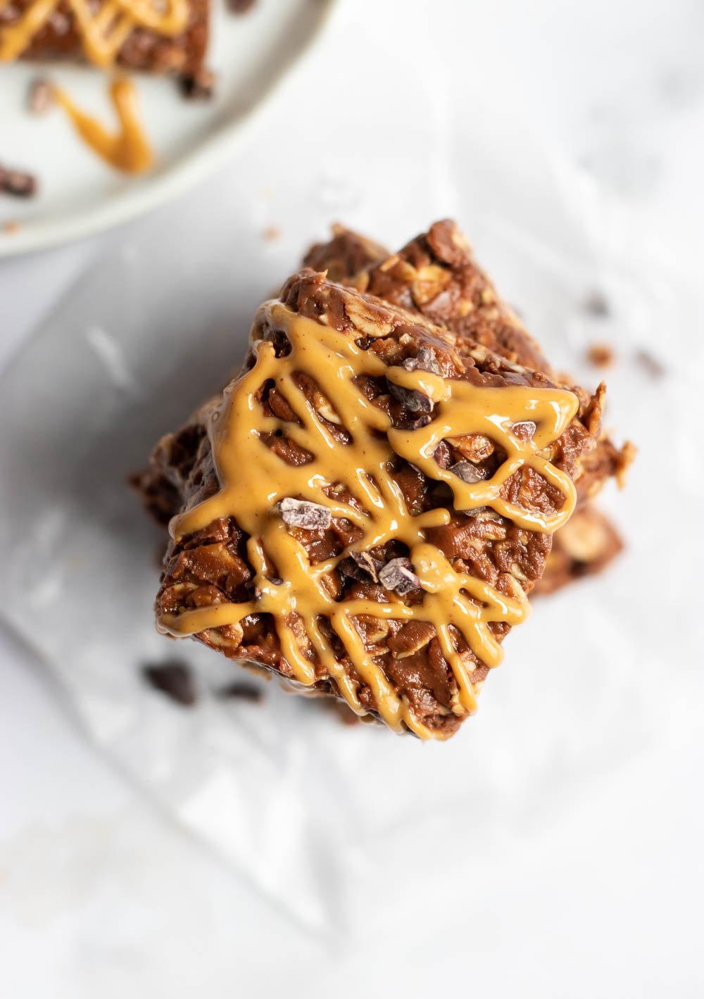 Overhead shot of peanut butter bars with chocolate chunks and peanut butter drizzle.