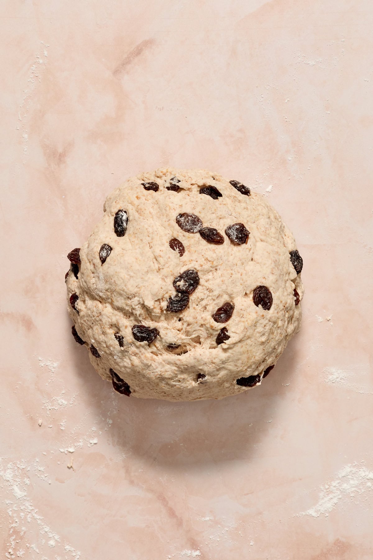 Rolled ball of cinnamon raisin bagel dough.