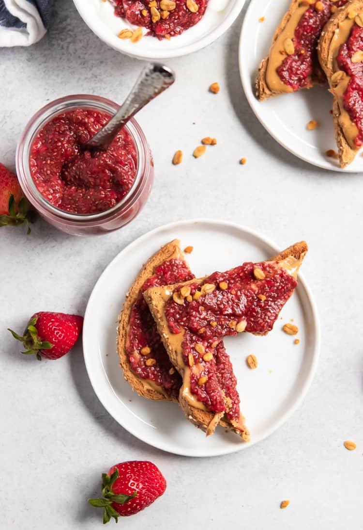 Overhead view of jam on peanut butter toast with bite taken out.