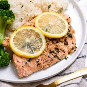 Instant Pot salmon on plate with rice and broccoli.