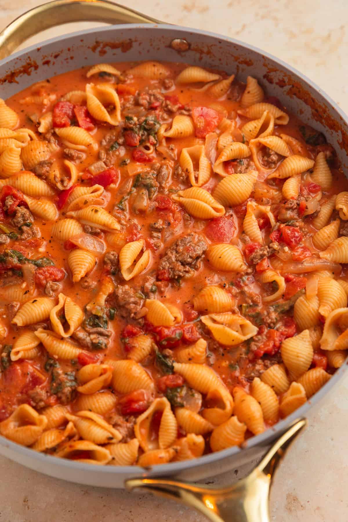 Ground beef pasta in tomato cream sauce in pan.
