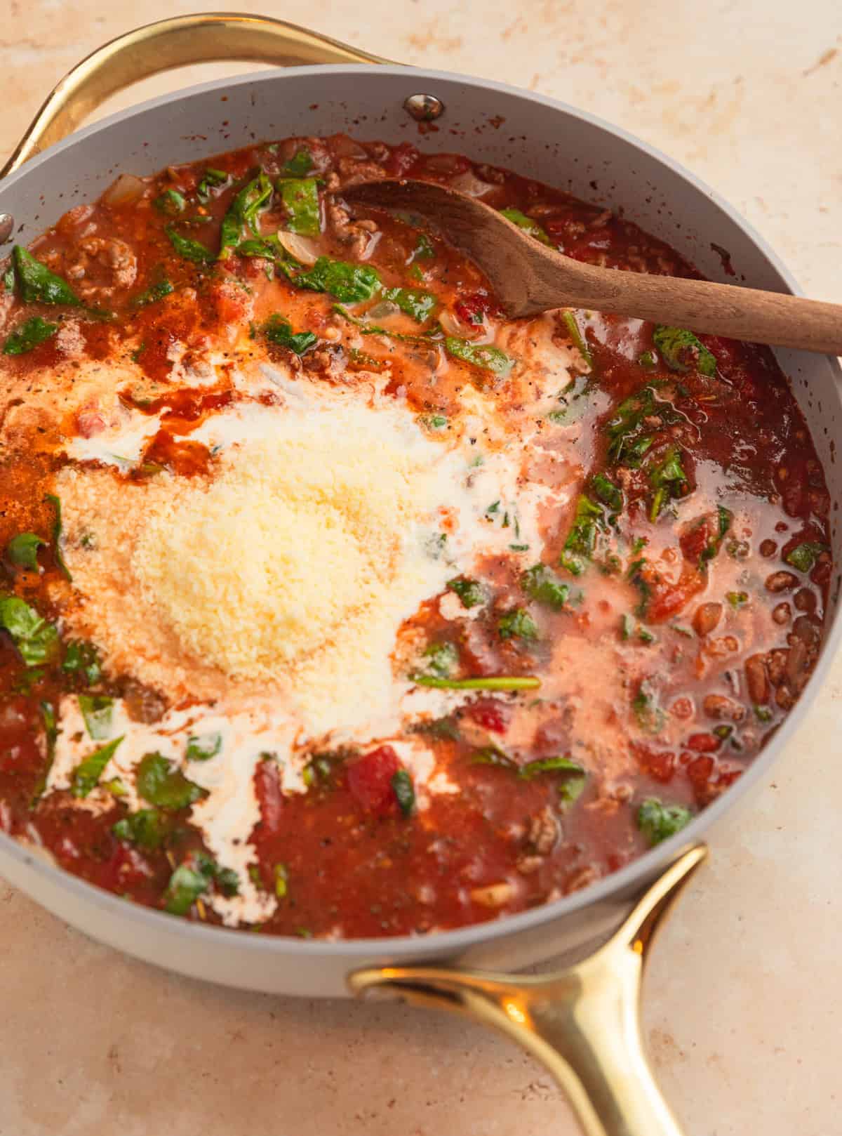 Cream and parmesan cheese added to pan.