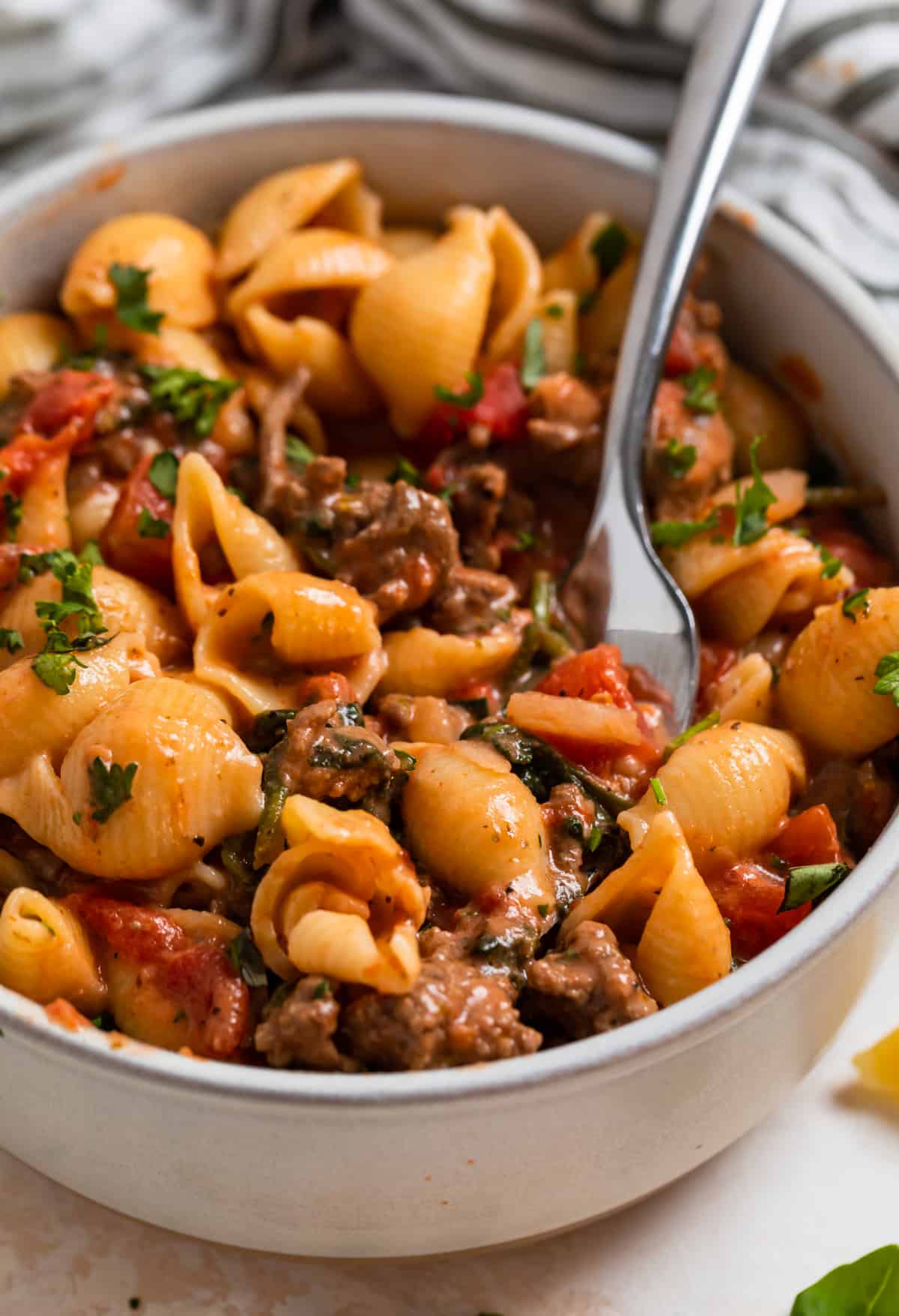 Bowl with beef pasta with fork in it.