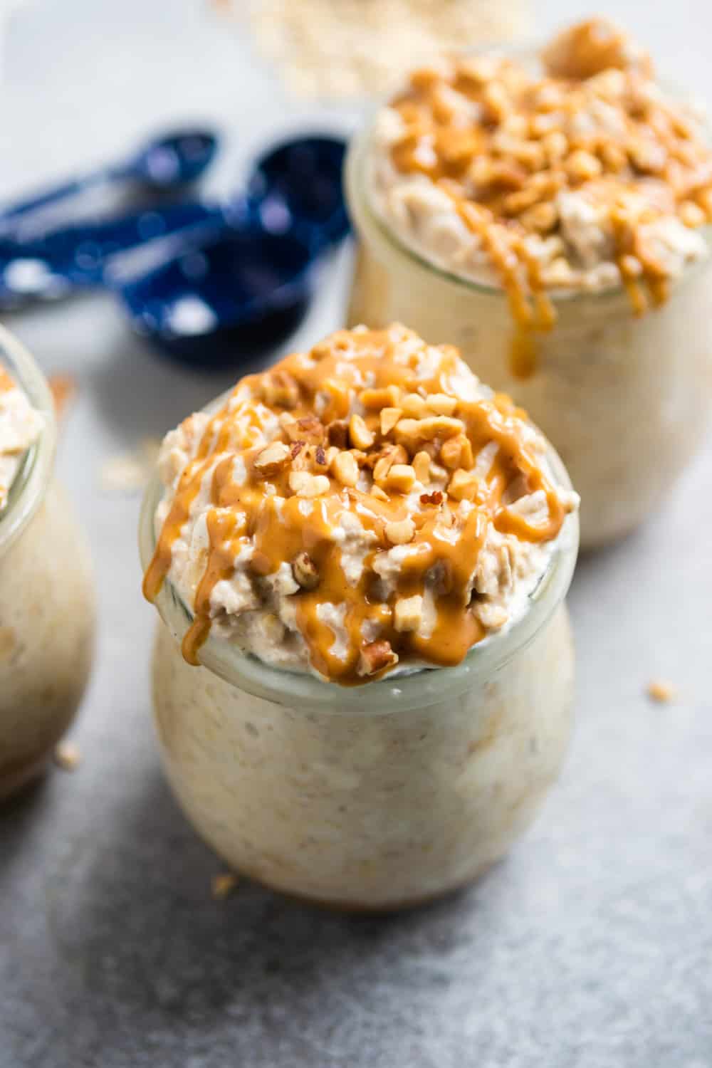 Peanut Butter Cheesecake Overnight Oats in jar with crushed peanuts.