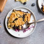 Overhead view of white plate with blueberry lemon dump cake.