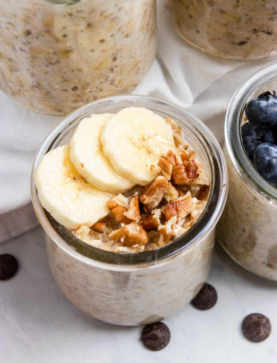 Banana Bread Overnight Oats in jar with banana slices and pecans.