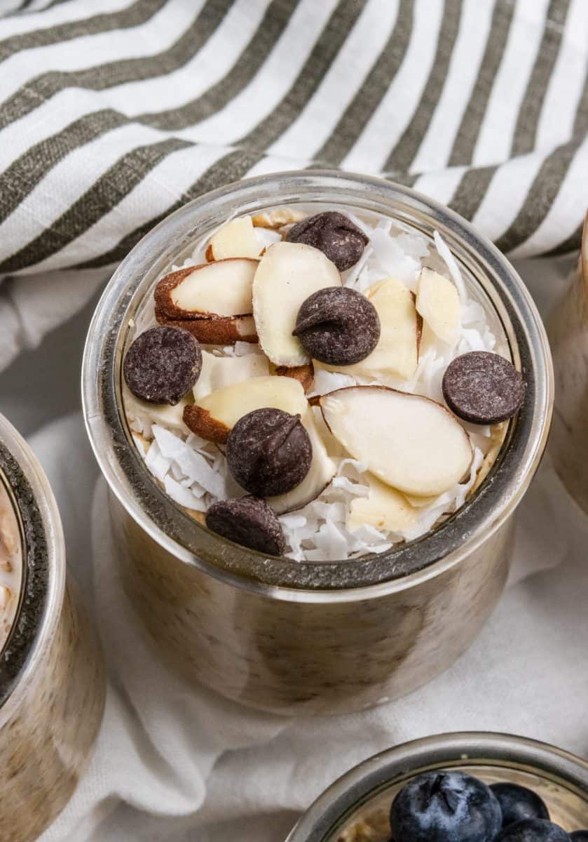 Almond joy overnight oats with slivered almonds, coconut and chocolate chips on top.