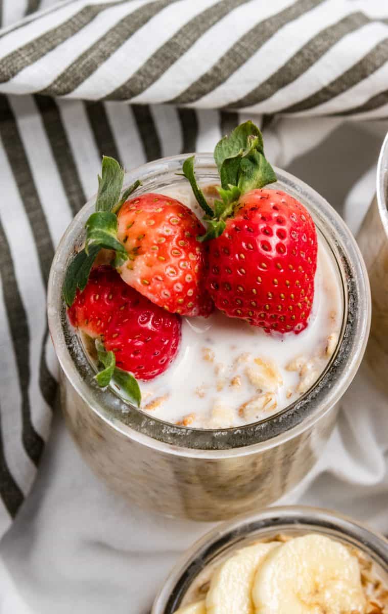 Strawberries and cream overnight oatmeal with sliced strawberries on top.