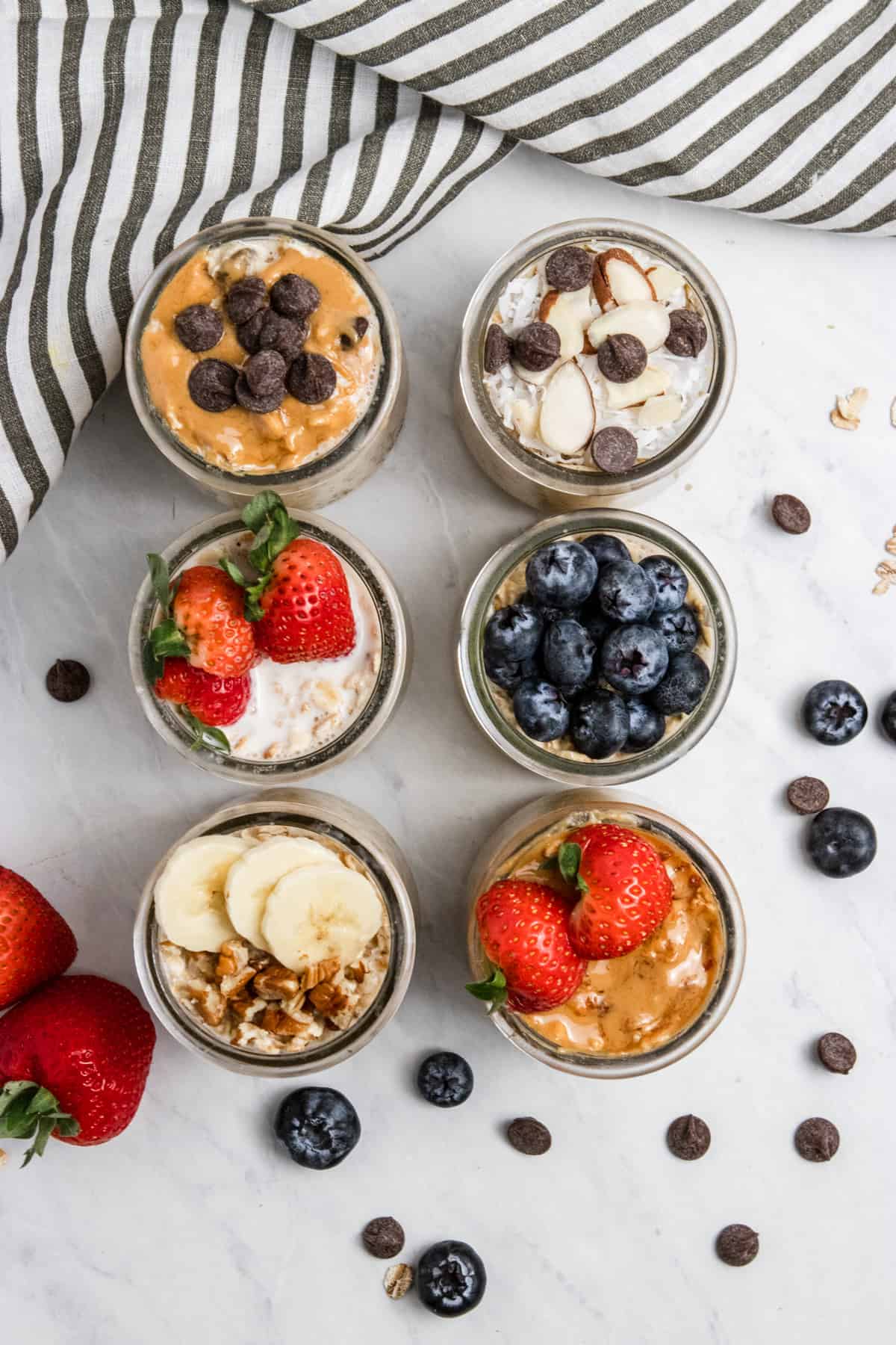 Overhead view of 6 jars of overnight oatmeal.