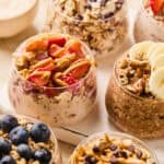 Overnight oatmeal prepared in glasses including several flavors: peanut butter and jelly, banana bread, blueberry muffin, etc.